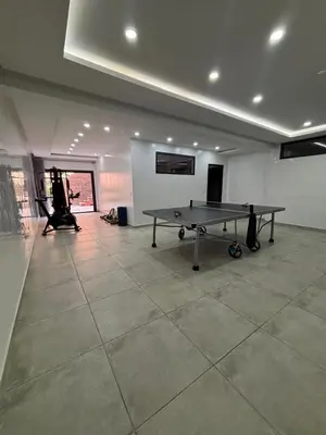 a ping pong table in an empty room with a ping pong table at Magnifique villa spacieuse Route de l'ourika in El Rhechat