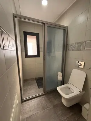 a bathroom with a shower and a toilet in it at Magnifique villa spacieuse Route de l'ourika in El Rhechat
