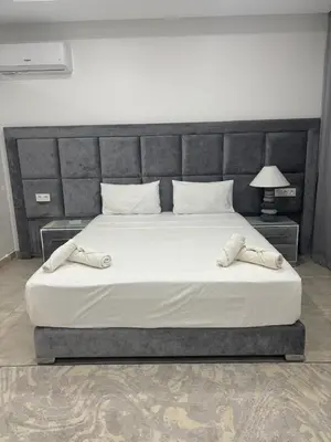 a bedroom with a large bed with a large headboard at Magnifique villa spacieuse Route de l'ourika in El Rhechat