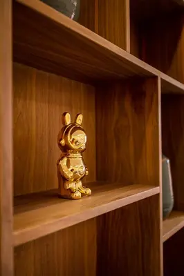 a small gold figurine on a wooden shelf at Elegant 2BR Modern Prime District in Marrakech in Marrakech