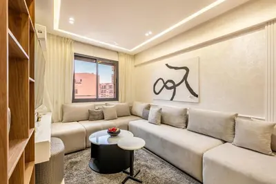 a living room with a couch and a table at Elegant 2BR Modern Prime District in Marrakech in Marrakech