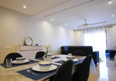 a dining room with a table and chairs at Appartement à Marrakech Terrasse et piscine in Marrakech