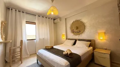 a bedroom with a bed with two slippers on it at Cozy apartment in Marrakech