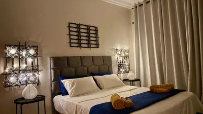 a bedroom with a large bed with blue and white at Cozy apartment in Marrakech