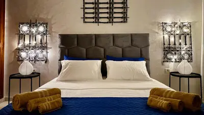 a bedroom with a large bed with a large headboard at Cozy apartment in Marrakech