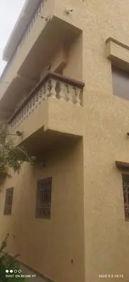 a building with a balcony on the side of it at Jolie petite villa in Marrakech