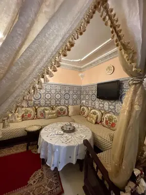 a living room with a table and a couch at chez Zaki in Marrakech