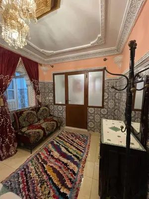 a living room with a couch and a rug at chez Zaki in Marrakech
