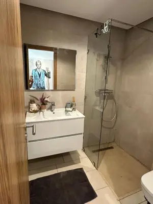 a bathroom with a sink and a shower at ART NORIA Private garden - pool view in Marrakech