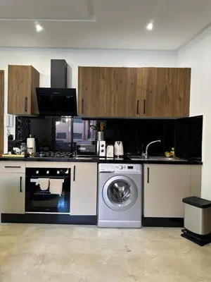 a kitchen with a stove and a washing machine at Studio prestige in Marrakech