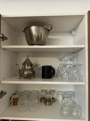 a shelf filled with glass jars and a tea kettle at Studio prestige in Marrakech