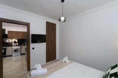 a bedroom with a bed and a mirror at Studio prestige in Marrakech