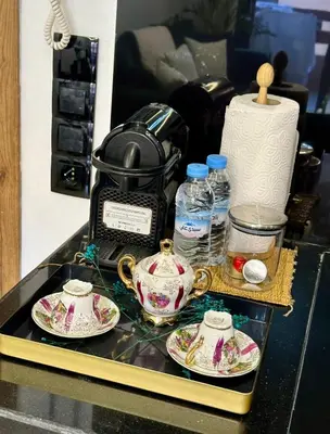 a table with two tea cups and a toaster at Studio prestige in Marrakech