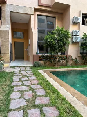 a house with a swimming pool next to a building at Studio prestige in Marrakech