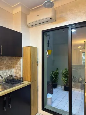 a kitchen with a sink and a glass door at Elégance marrakech in Marrakech