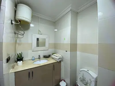 a bathroom with a sink and a toilet and a mirror at Elégance marrakech in Marrakech