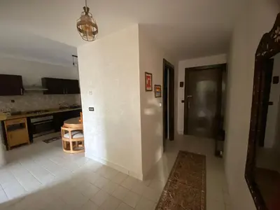 a living room with a kitchen and a dining room at Elégance marrakech in Marrakech