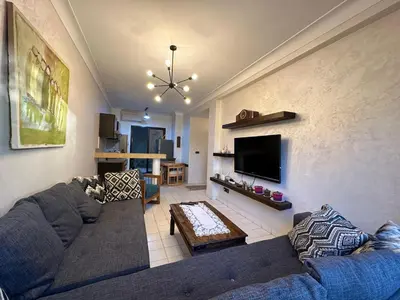 a living room with a couch and a tv at Elégance marrakech in Marrakech