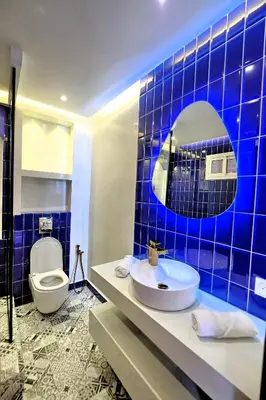 a blue tiled bathroom with a sink and a toilet at Luxury Apartment Retreat in Marrakech in Marrakech