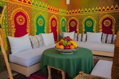 a room with a table with a bowl of fruit on it at Riad Eljazouli in Marrakech