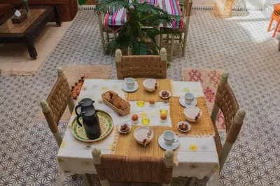 a table with a plate of food on it at Riad Eljazouli in Marrakech