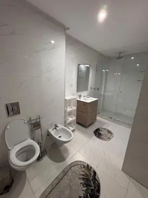 a bathroom with a toilet and a sink and a shower at Your Host in Marrakech