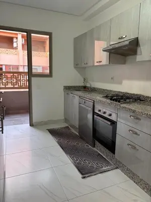 a kitchen with stainless steel appliances and a stove at Your Host in Marrakech