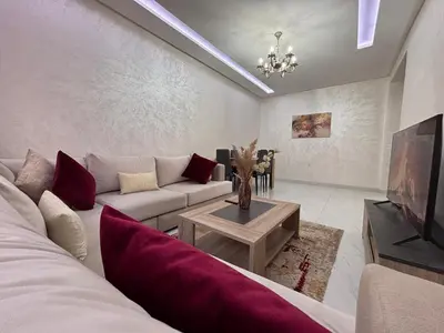 a living room with a couch and a tv at Your Host in Marrakech