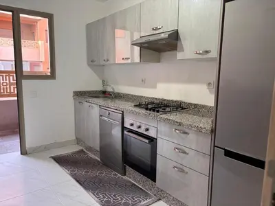 a kitchen with a stove and a refrigerator at Your Host in Marrakech
