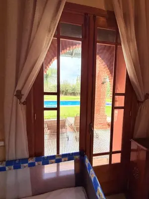 a room with a window and a view of a patio at VILLA 33 - 4 Master Suites, Stylish Moroccan Design & Private Pool in Marrakech