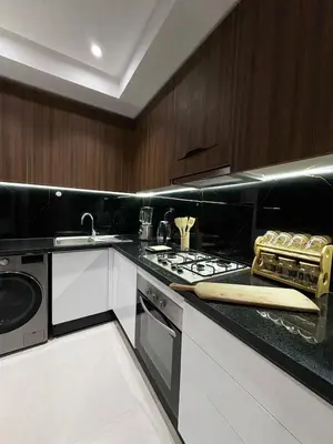 a kitchen with a stove and a counter top at Appartement de Luxe 3 Chambres avec piscine au centre in Marrakech