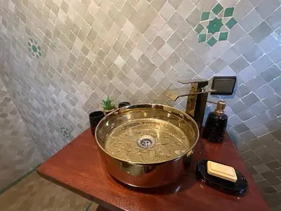a pot on a wooden counter with a sink at Riad Talal in Marrakech