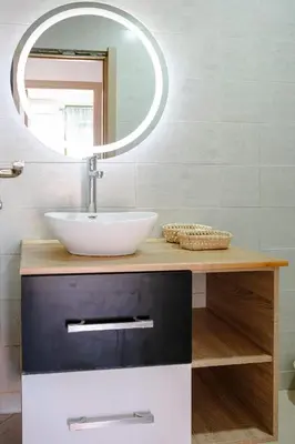a bathroom with a sink and a mirror at Séjour confort jacuzzi et terrasse à Targa in Marrakech
