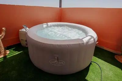 a large white bath tub sitting in a room at Séjour confort jacuzzi et terrasse à Targa in Marrakech