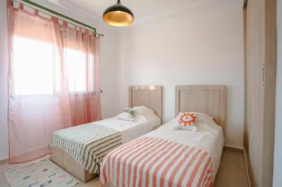 two beds sitting next to each other in a room at Séjour confort jacuzzi et terrasse à Targa in Marrakech