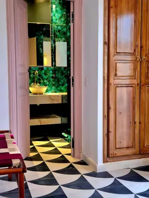 a hallway with a bathroom with a sink and a door at Riad Beltza - 