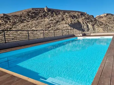 a swimming pool with a mountain in the background at Elegant 2BDR Apartment with Pool in Gueliz in Marrakech