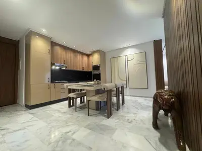 a kitchen with a table and chairs in a room at Elegant 2BDR Apartment with Pool in Gueliz in Marrakech