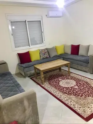 a living room with a couch and a coffee table at Residence Jnane Tissir Marrakech in Marrakech