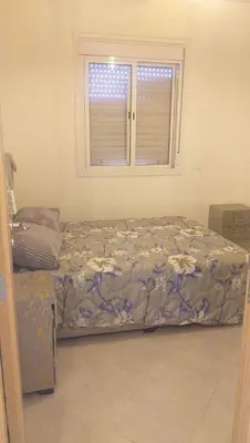 a bedroom with a bed and a window at Residence Jnane Tissir Marrakech in Marrakech