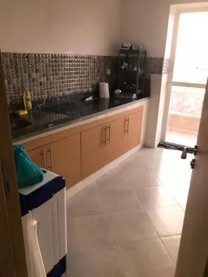 a kitchen with a sink and a counter at Residence Jnane Tissir Marrakech in Marrakech