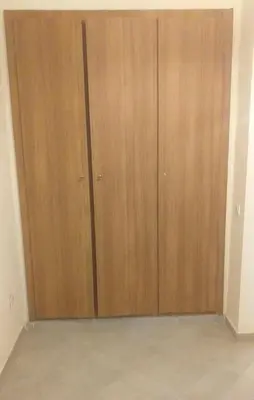 a pair of wooden closet doors in a room at Residence Jnane Tissir Marrakech in Marrakech