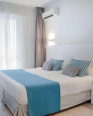a bedroom with a large bed with pillows on it at Dar lhssn in Marrakech