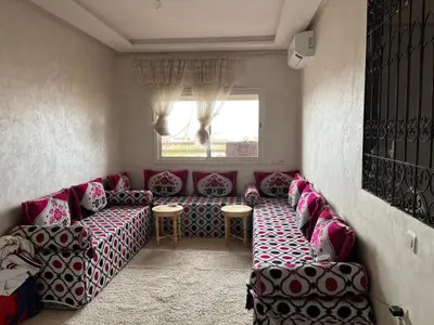 a living room with a couch and a window at Marrakech in Marrakech