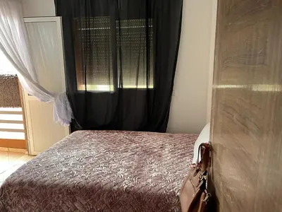 a bedroom with a bed with a black curtain at Marrakech in Marrakech