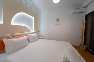 a bedroom with a large white bed with white pillows at Gueliz Central Apartment with Pool and Parking in Marrakech
