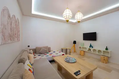 a living room with a couch and a table at Gueliz Central Apartment with Pool and Parking in Marrakech