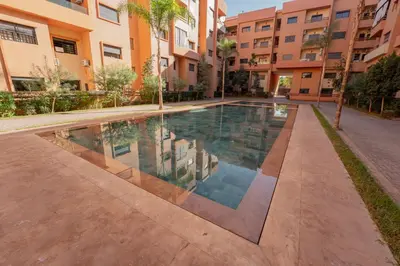 a swimming pool in the middle of a building at Gueliz Central Apartment with Pool and Parking in Marrakech
