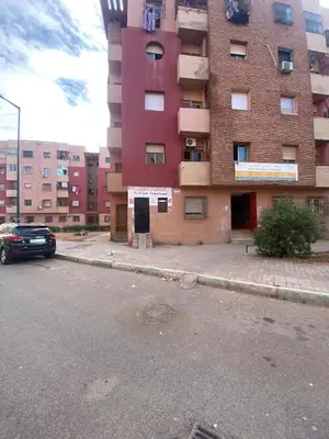 a parking lot in front of a tall building at Marrakech house Your Haven of Peace in Marrakech in Marrakech