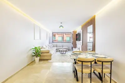 a living room with a table and a couch at Luxury 1BR in gueliz in Marrakech
